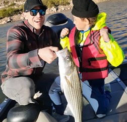 AZ Fishing trip customer with child and large fish